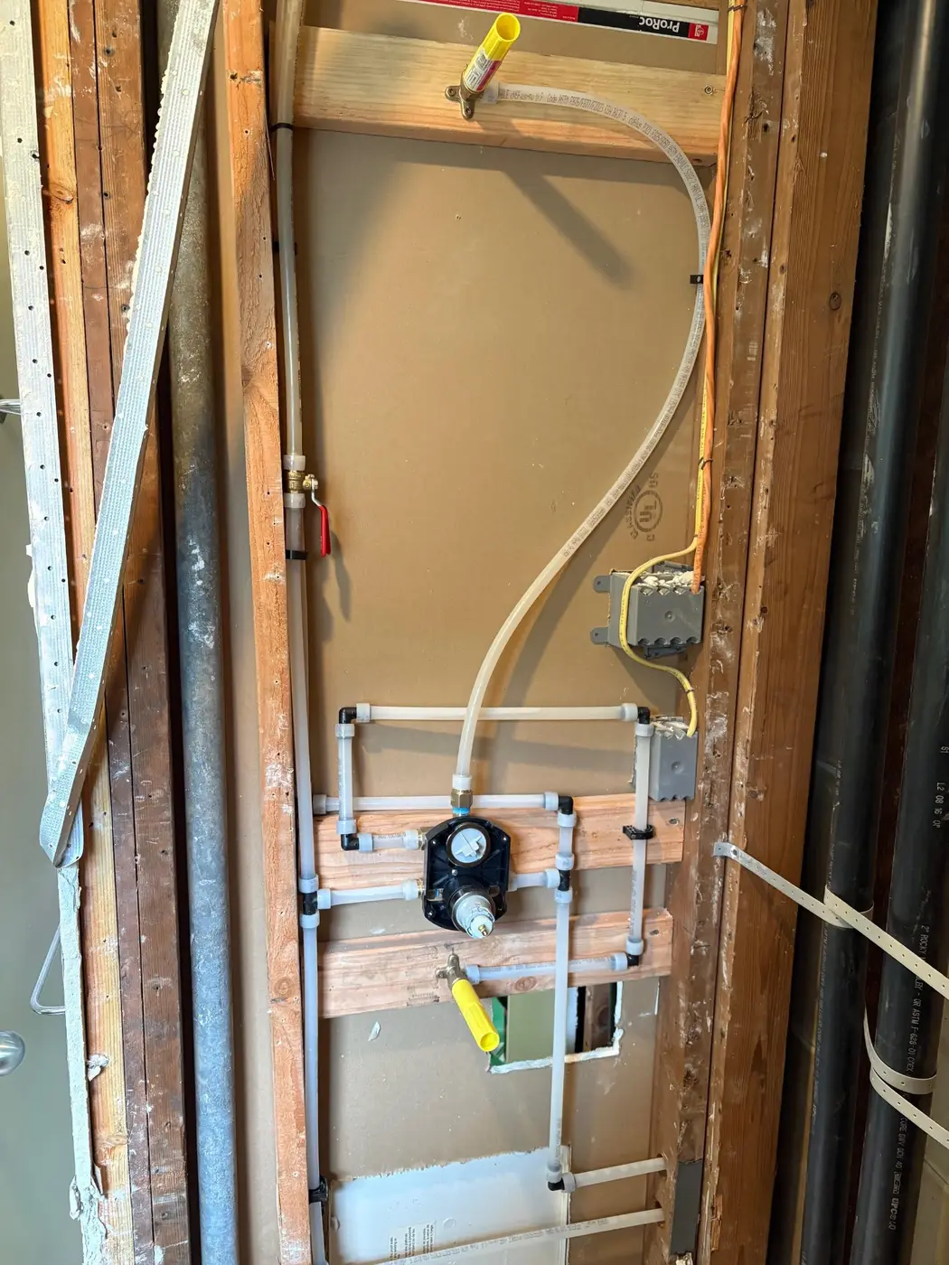 Bathroom rough-in plumbing with PEX manifold and shower valve by Wild Pine Plumbing in Columbia County, Oregon