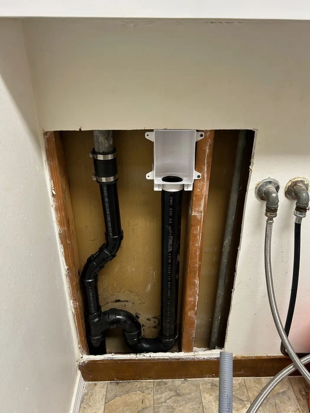 Washing machine outlet box with ABS drain and stainless steel supply lines roughed in by Wild Pine Plumbing in St Helens, Oregon
